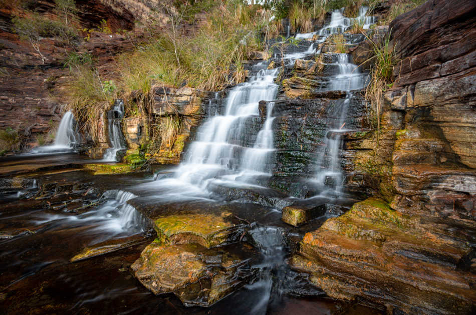 The detail in the rocks creates interest, and the patterns of the water moving through the rocks  guides the eye towards the main subject, the waterfall