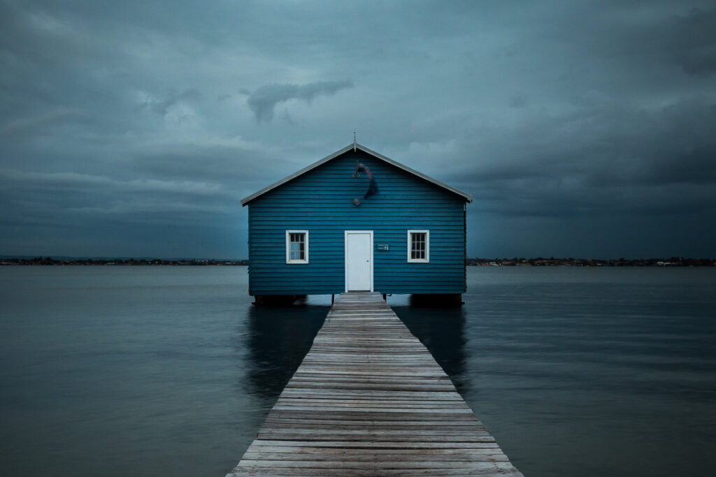 A simple composition of a blue boat house. It's clear what the main subject is.
