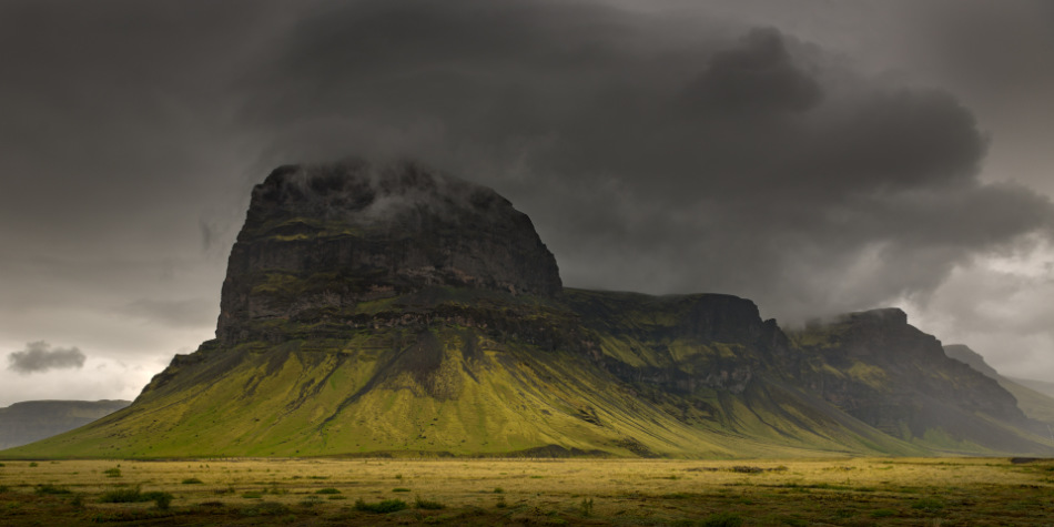 A significant portion of the image is dedicated to the dark, stormy clouds, creating the mood within the photo.