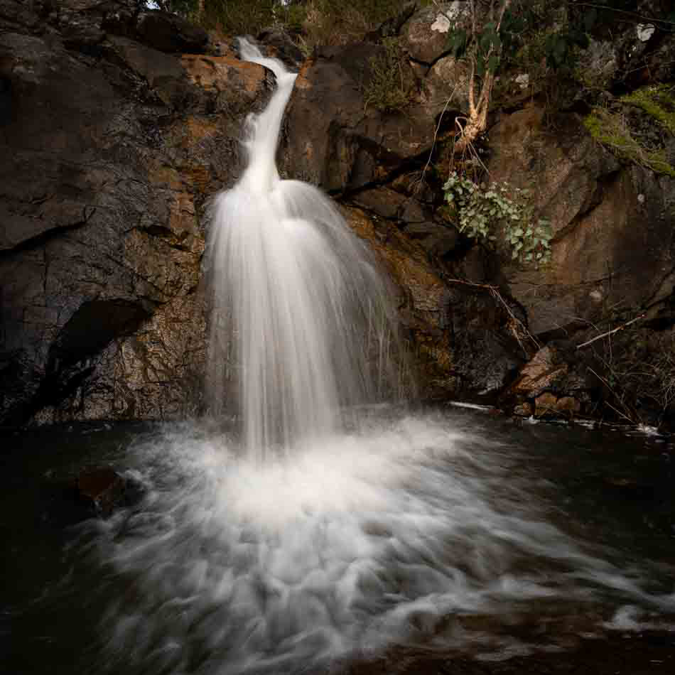 As the waterfall hits the water below, it creates patterns in the foreground.